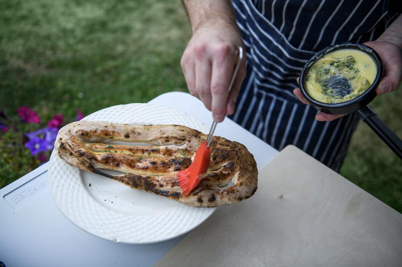 Garlic bread being prepared at Pizza Strada